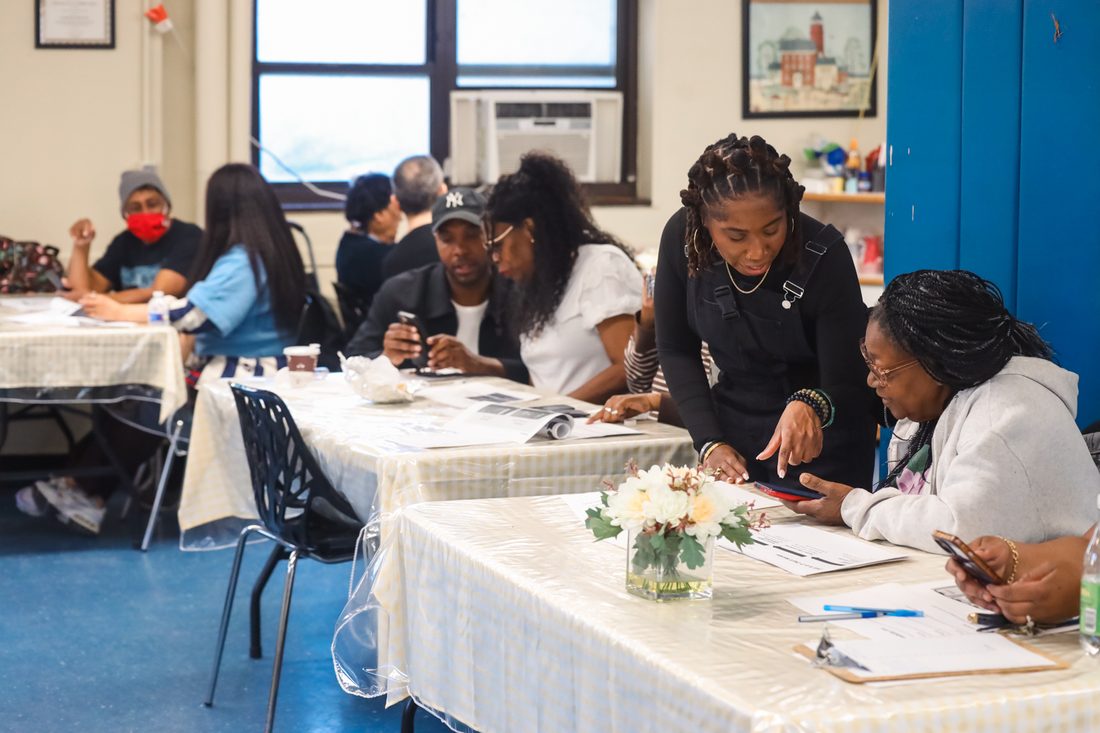 Volunteers, seniors, and older adults working together at tables